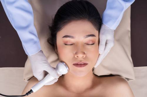 woman receiving ultrasound facial beauty treatment skin care